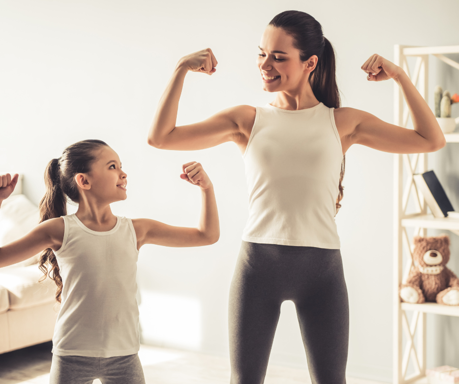 mother and daughter standing next to each other flexing